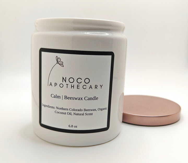 Calm beeswax candle with lid off against white background | NoCo Apothecary